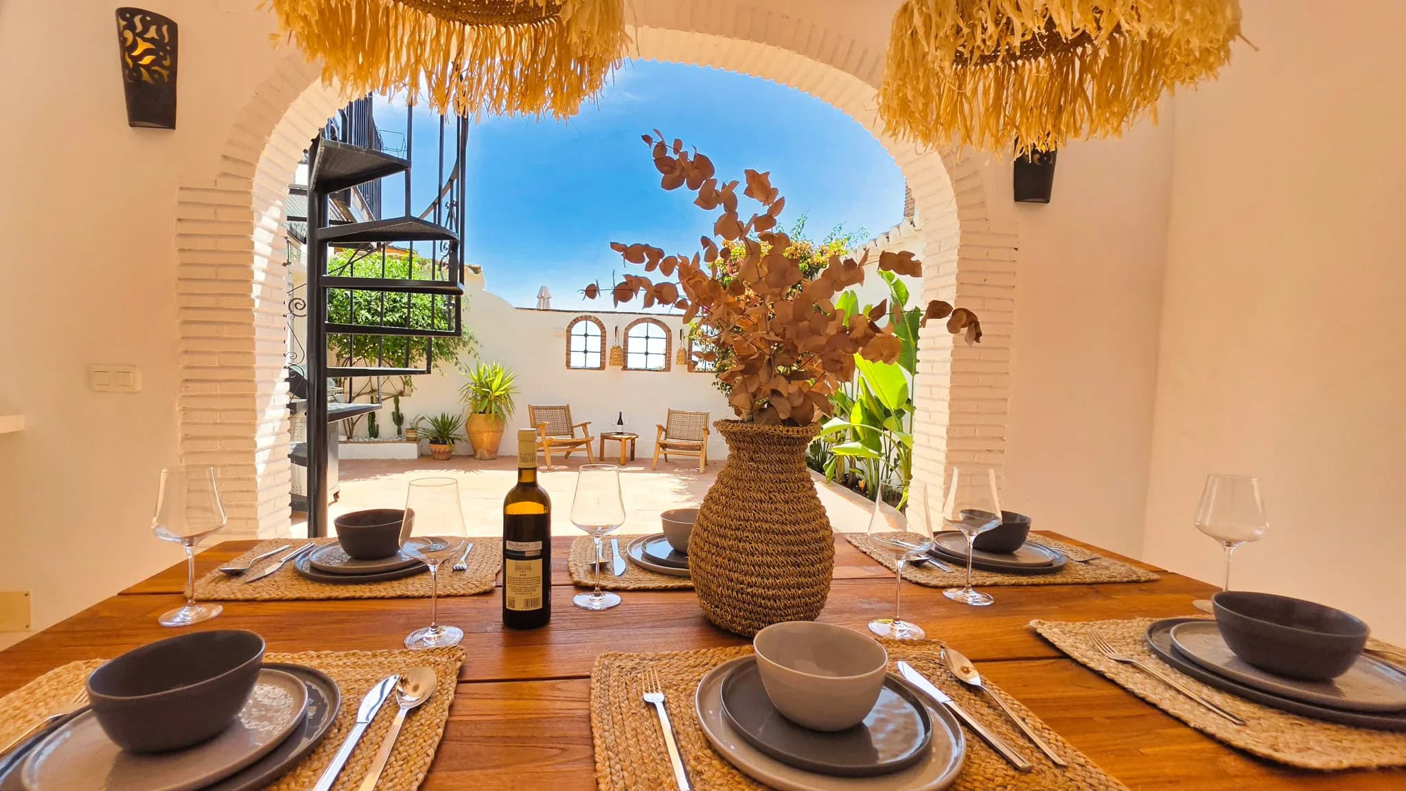 A cozy dining area overlooking a sunny patio, perfect for a holiday in Spain.
